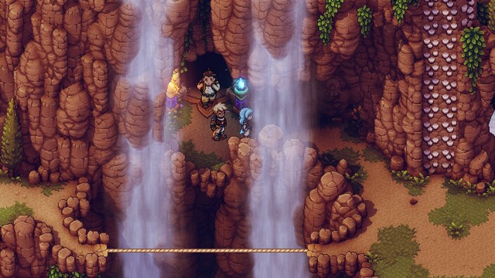 Screenshot showing the party in a mountain range behind waterfalls